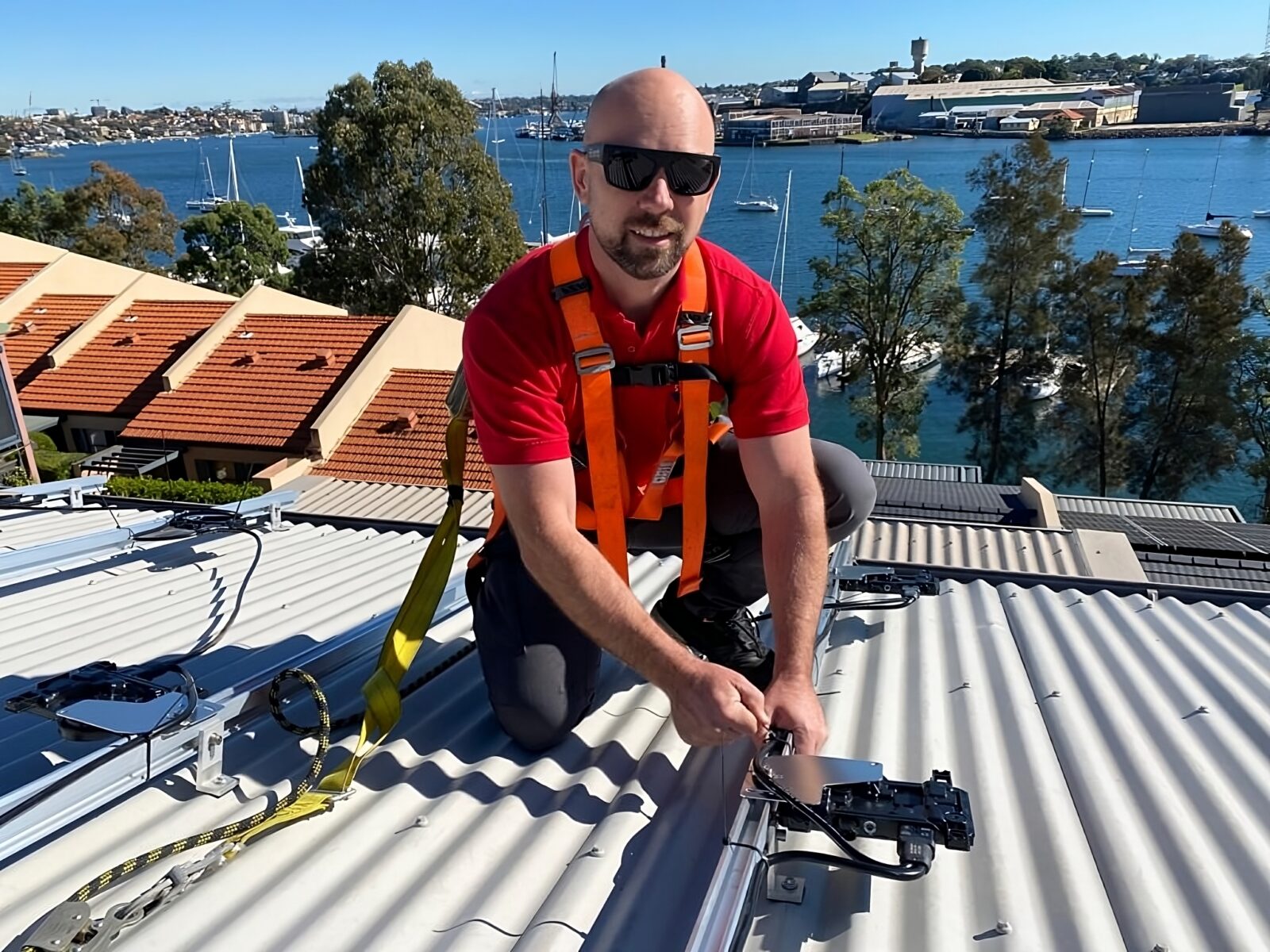 Solar Installer on roof installing Microinverters