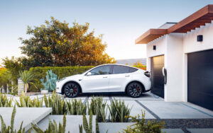White electric SUV charging at modern home garage