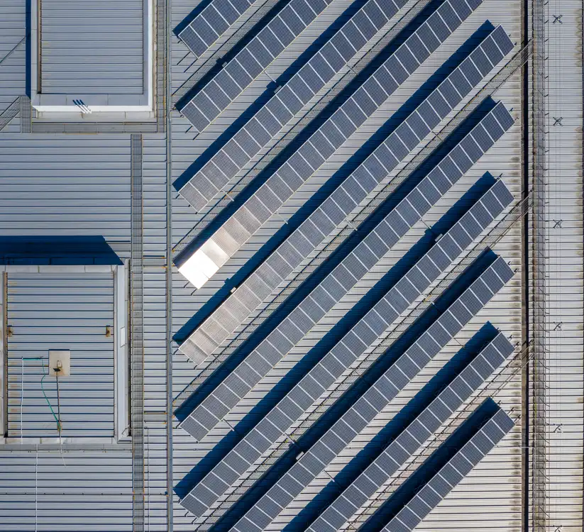 Rows of solar panels installed on a commercial building roof
